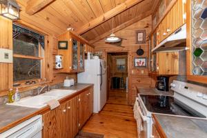 a kitchen with wooden cabinets and a white refrigerator at Hayloft in Townsend +15 photos