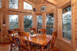 a dining room with a wooden table and chairs at Hayloft in Townsend