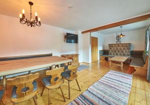 a dining room with a table and chairs and a couch at Ferienhaus Oberlengau in Saalbach-Hinterglemm