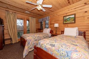 a bedroom with two beds and a ceiling fan at Hayloft in Townsend