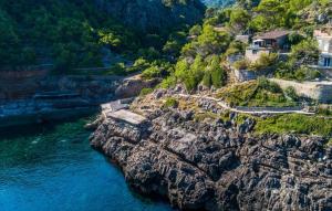 an aerial view of a rocky mountain with the ocean at Amaret in Deia