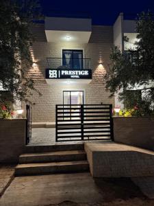 a building with a sign on the front of it at Prestige Hotel in Ksamil