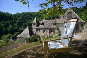 a swing in front of a house at Castel de Grafeuille in Hautefage