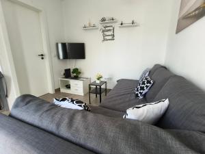 a living room with a couch and a tv at O Refúgio in Mértola +4 photos