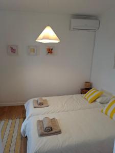 two beds in a room with towels on them at Casa D Alma in Aljustrel