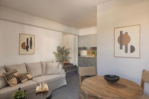 a living room with a couch and a table at Annas's Main Street Apartment in Skala