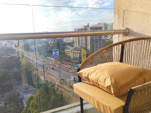 a balcony with a window with a view of a city at Askarium Cozy Haven in Nairobi