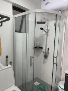 a glass shower in a bathroom with a toilet at Askarium Cozy Haven in Nairobi