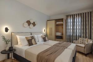 a bedroom with a large bed and a chair at Annas's Main Street Apartment in Skala