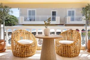 a patio with a table and chairs and a building at Annas's Main Street Apartment in Skala