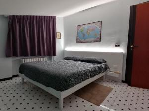 a bedroom with a bed in a room with a window at Attico D'Andrea in Pratola Peligna