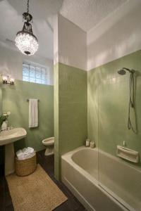 a bathroom with a tub and a toilet and a sink at Shared rooms BOC in Brunate