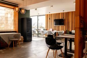a room with a table and chairs and a television at Vila Victor Mizuumi in Mamaia
