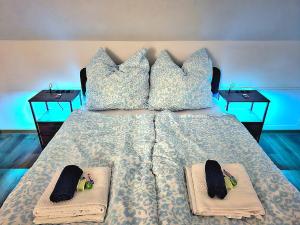 a bed with two pairs of slippers on it at Helle Dachgeschosswohnung, neu renoviert & ruhig in Wolfenbüttel