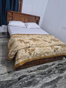 a bedroom with a bed with a comforter at Velankanni Home Stay in Mangalore
