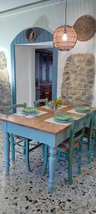 a wooden table with chairs and a dining room at La Collina dei Conigli - immersi nella natura in Castellarano