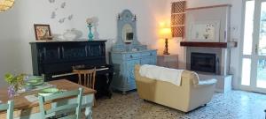 a living room with a table and a chair at La Collina dei Conigli - immersi nella natura in Castellarano
