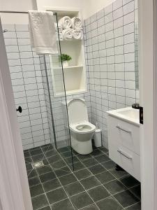 a bathroom with a toilet and a sink at The Old Parish Office! in Midleton +15 photos