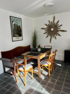 a dining room with a wooden table and chairs at The Old Parish Office! in Midleton