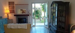 a living room with a couch and a fireplace at La Collina dei Conigli - immersi nella natura in Castellarano