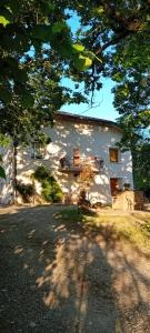 a large white building with a balcony on the side of it at La Collina dei Conigli - immersi nella natura in Castellarano