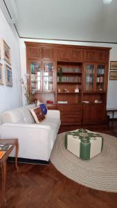 a living room with a white couch and a table at Appartamento Storico a Palmanova in Palmanova