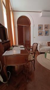 a living room with a table and a couch at Appartamento Storico a Palmanova in Palmanova +10 photos