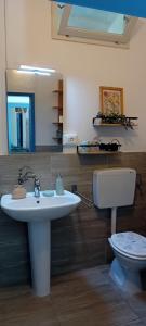 a bathroom with a white sink and a toilet at La Collina dei Conigli - immersi nella natura in Castellarano +25 photos