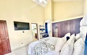 a bedroom with a large bed with white pillows at Bright & Modern Apartment in Puerto Plata, Secure, and Central! in San Felipe de Puerto Plata