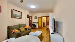 a living room with a couch and a tv at Jaca Centrum in Jaca