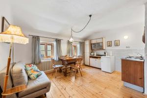 a kitchen and living room with a couch and a table at Alter Brotladen - Melk Center in Melk