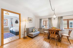 a living room with a table and a couch at Alter Brotladen - Melk Center in Melk +14 photos