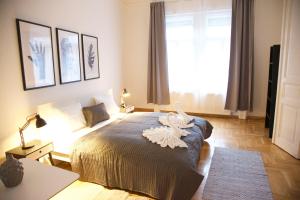 a bedroom with a bed with a white bird on it at Five Season's Apartment in Budapest
