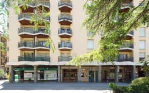an apartment building with balconies on a street at Jaca Centrum in Jaca