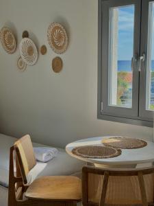a room with a table and two chairs and a window at Venetia in Tsoutsouros