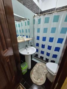 a bathroom with a toilet and a sink at Heart Haven Retreat in Sipalay