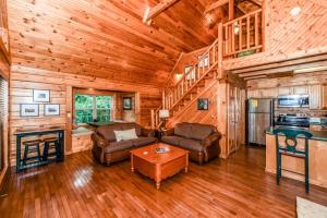 a living room with a couch and a table in a cabin at Serenity in Townsend