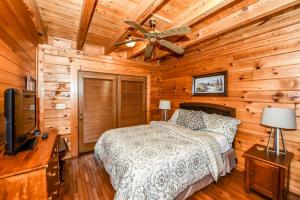 a bedroom with a bed and a ceiling fan at Serenity in Townsend