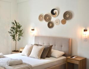 a bedroom with a bed with plates on the wall at Venetia in Tsoutsouros