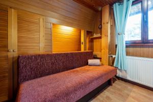 a bench in a room with a window at Squirrel cottage Chata Veverica in Dolná Lehota