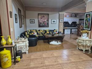 a living room with a couch and a table at Heart Haven Retreat in Sipalay