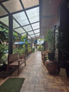 a walkway with benches and plants in a building at Heart Haven Retreat in Sipalay