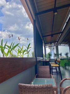 a balcony with chairs and a table and some plants at PrimeBiz Tegal in Tegal