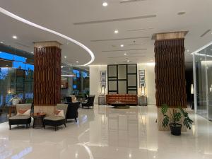 a lobby with two large pillars in a building at PrimeBiz Tegal in Tegal +41 photos