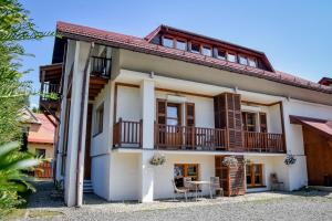 a house with a balcony and a table at Villa Cynamon Jacuzzi & Sauna in Wisła