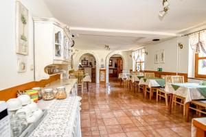 a kitchen and dining room with tables and chairs at Villa Cynamon Jacuzzi & Sauna in Wisła