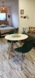 a room with a table and two chairs and a bed at Casa cronopio in Ushuaia