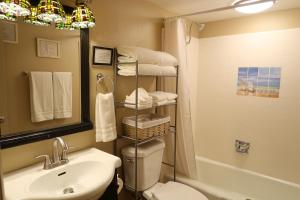 a bathroom with a sink and a toilet and towels at Dumplin Patch Bed & Breakfast in Williams +27 photos