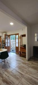 an empty living room with a table and a kitchen at Casa cronopio in Ushuaia