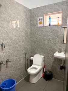 a bathroom with a toilet and a sink at Whitefort Family Villa Alleppy-Homestay in Alleppey +24 photos